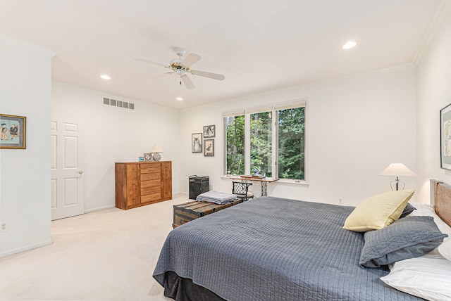 bedroom featuring ceiling fan, ornamental molding, and light carpet