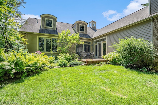 rear view of property featuring a yard