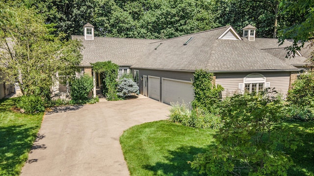 view of front of house with a garage and a front lawn