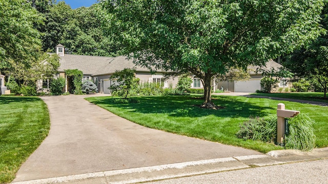 view of front facade with a garage and a front lawn