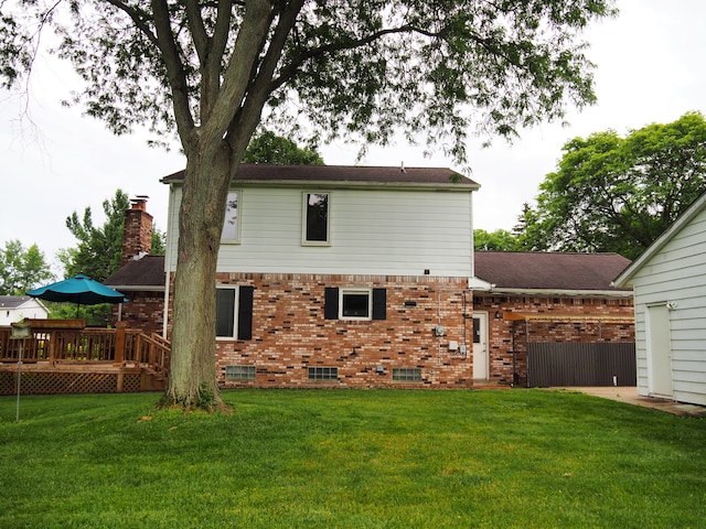 back of property with a yard and a deck