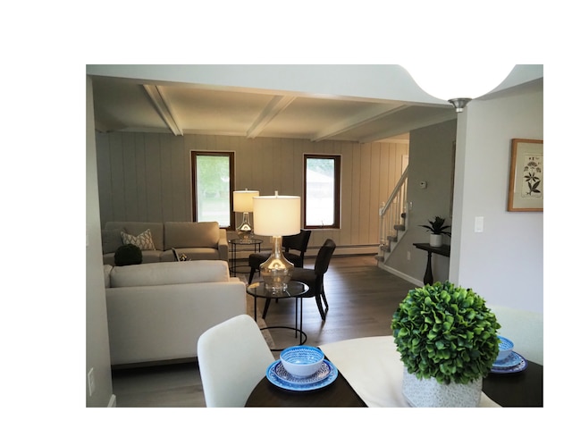 living room with beam ceiling, wood walls, wood-type flooring, and a baseboard heating unit