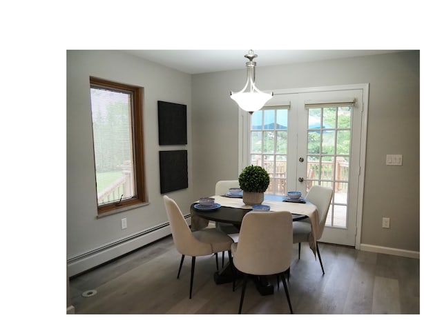 dining room with wood-type flooring, french doors, and baseboard heating