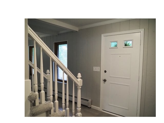 entrance foyer with beamed ceiling, crown molding, and wooden walls