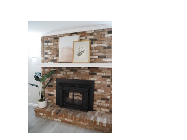 details with hardwood / wood-style flooring, a fireplace, and crown molding