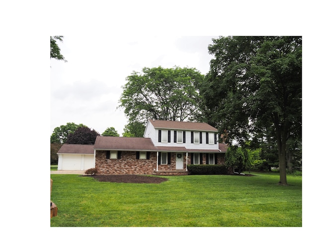 view of front of house with a porch, a garage, and a front lawn