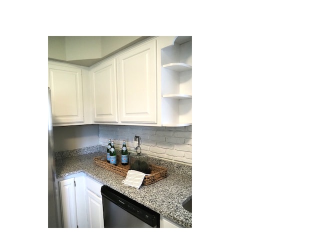 kitchen featuring decorative backsplash, white cabinetry, stainless steel dishwasher, and light stone counters