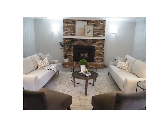 living room featuring wooden walls and a brick fireplace