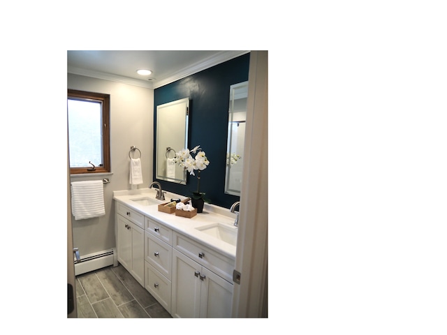 bathroom with hardwood / wood-style flooring, vanity, ornamental molding, and a baseboard radiator