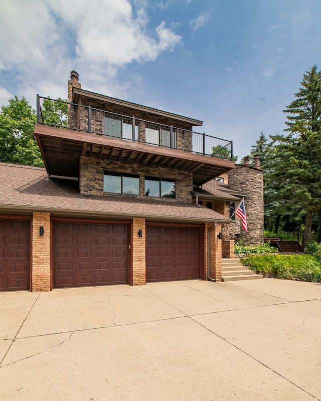 view of front of house with a balcony and a garage