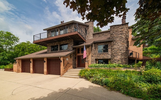 view of front of home with a balcony and a garage