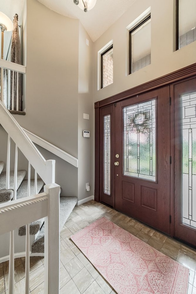 foyer with high vaulted ceiling