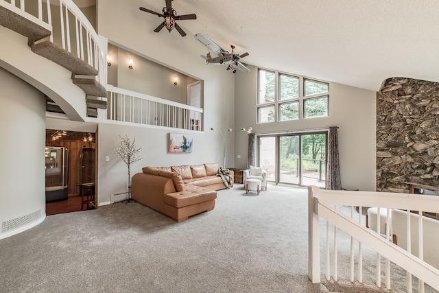 living room featuring carpet flooring, a textured ceiling, ceiling fan, a baseboard heating unit, and high vaulted ceiling