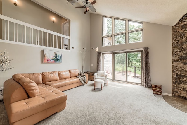 carpeted living room featuring a wealth of natural light, high vaulted ceiling, a textured ceiling, and ceiling fan