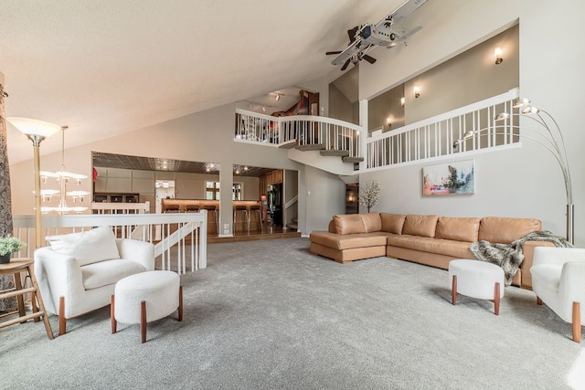 carpeted living room featuring ceiling fan and high vaulted ceiling