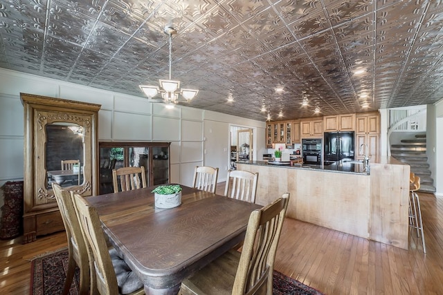 dining room with hardwood / wood-style flooring and sink