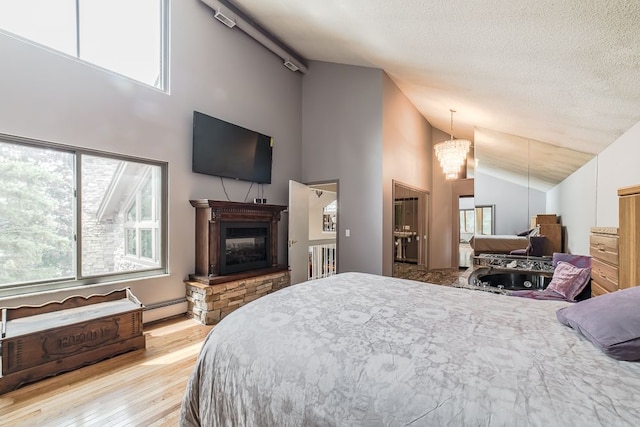 bedroom with high vaulted ceiling, an inviting chandelier, a textured ceiling, a baseboard radiator, and light hardwood / wood-style floors