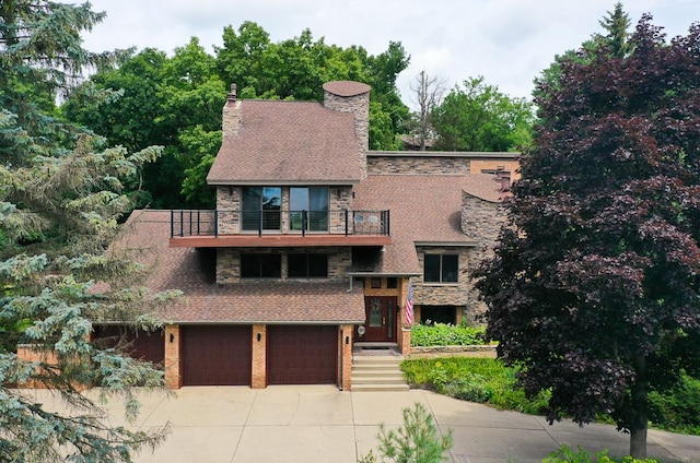 view of front of home with a balcony and a garage