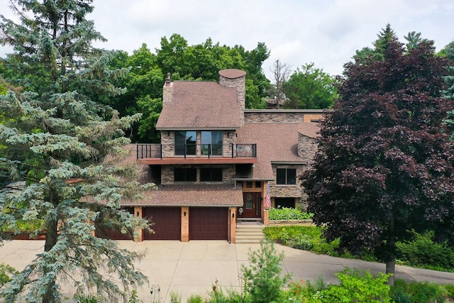 view of front of home featuring a garage and a balcony