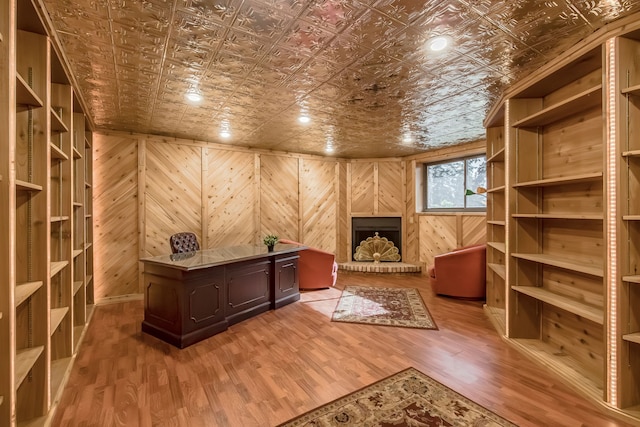 unfurnished office featuring hardwood / wood-style flooring and wood walls