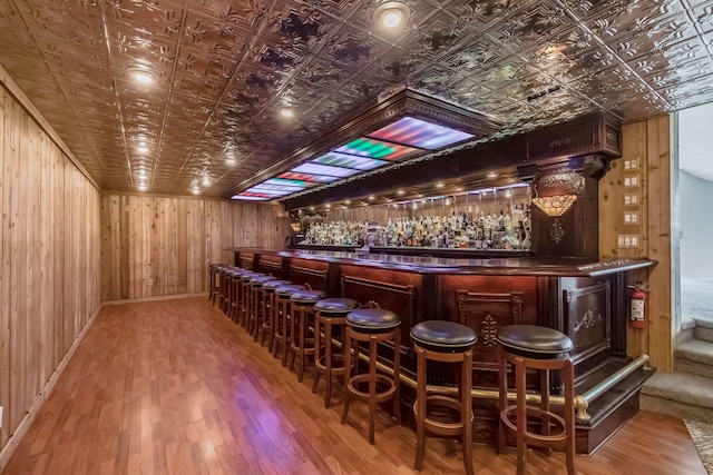 bar with wood walls and wood-type flooring