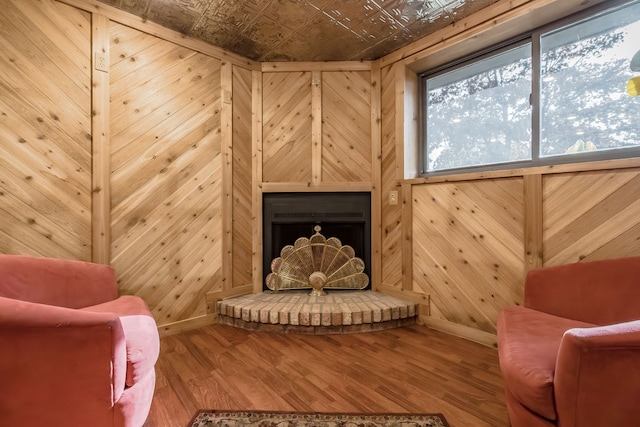 living area with wood walls and wood-type flooring