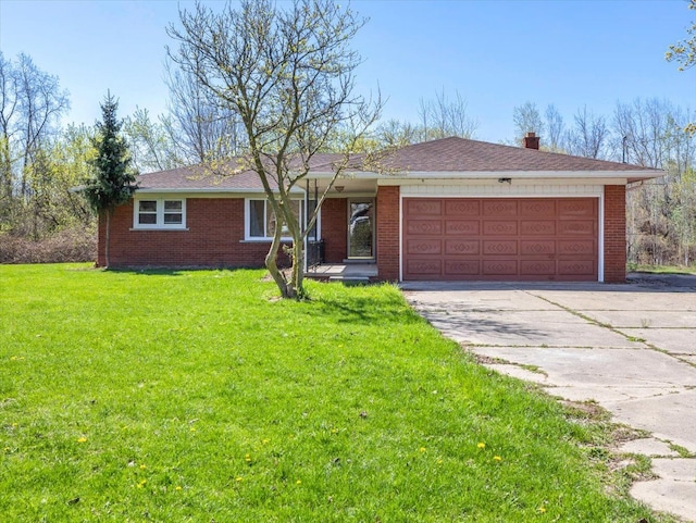 single story home featuring a garage, concrete driveway, brick siding, and a front lawn