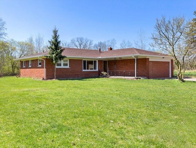 view of front of property with a garage and a front lawn