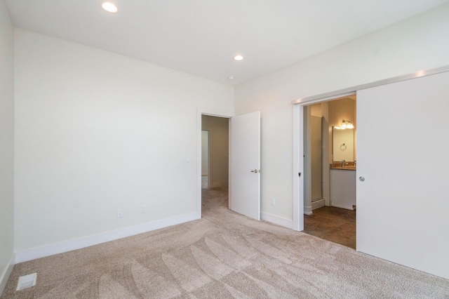 spare room featuring light colored carpet