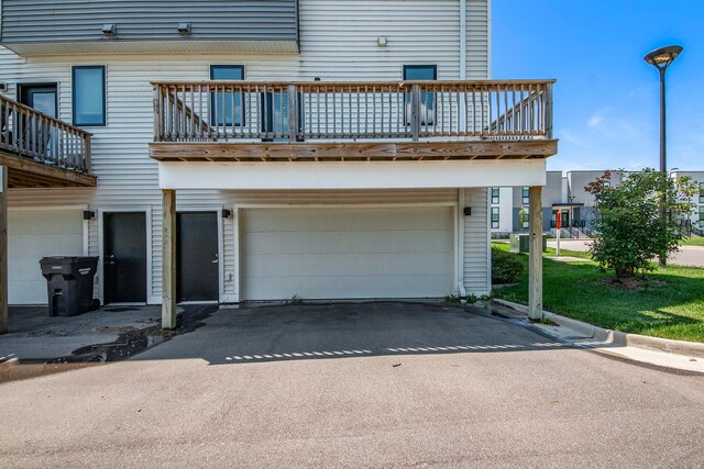 exterior space with a balcony and a garage