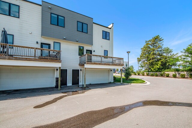 rear view of property featuring a garage