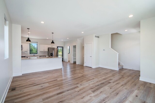 unfurnished living room with light hardwood / wood-style flooring