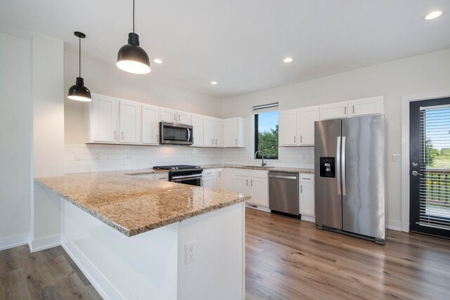 kitchen with plenty of natural light, white cabinets, and stainless steel appliances