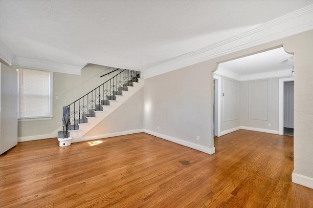 unfurnished room with hardwood / wood-style flooring and crown molding