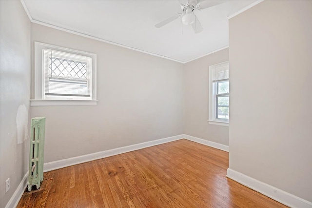 unfurnished room featuring ceiling fan, crown molding, and wood-type flooring