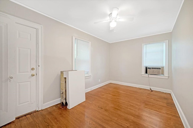 unfurnished room with hardwood / wood-style flooring, ceiling fan, cooling unit, and crown molding