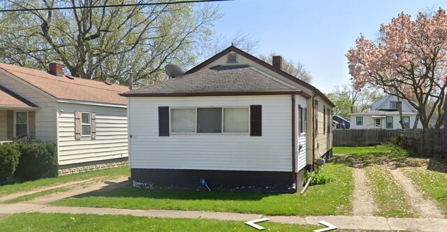 view of property exterior with a lawn