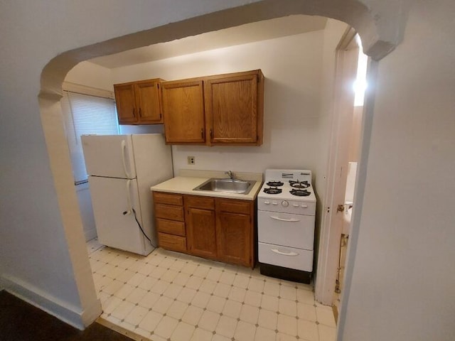 kitchen with white appliances and sink