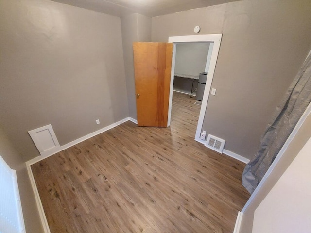 spare room featuring light hardwood / wood-style floors