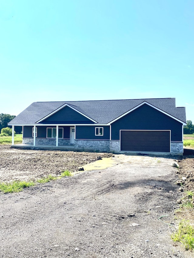 view of front facade featuring a porch and a garage