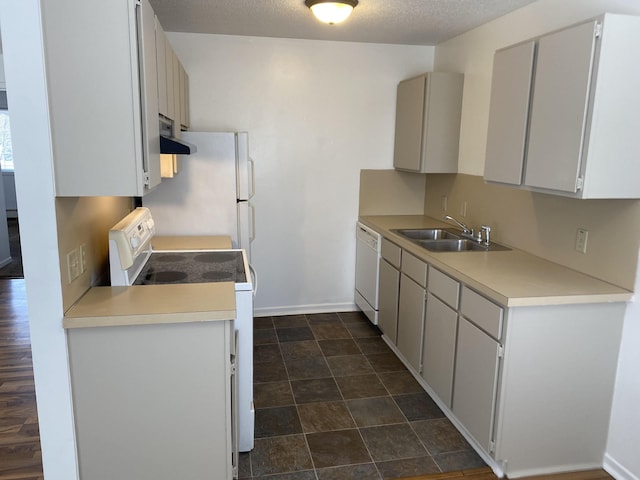 kitchen with white appliances, sink, a textured ceiling, range hood, and white cabinetry