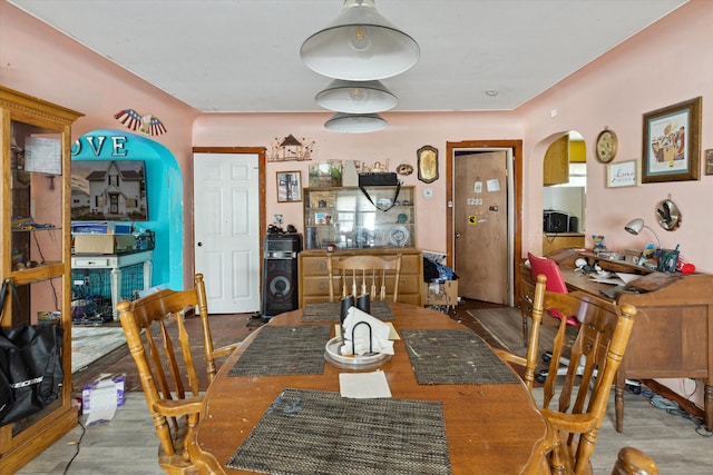 dining space featuring wood-type flooring