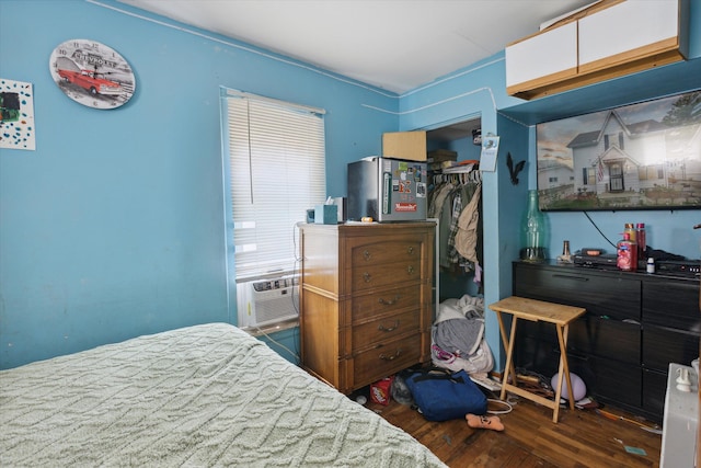 bedroom featuring dark hardwood / wood-style flooring, a closet, and cooling unit