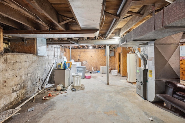 basement featuring gas water heater and heating unit