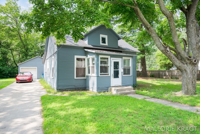 bungalow-style home with an outbuilding, a front lawn, and a garage