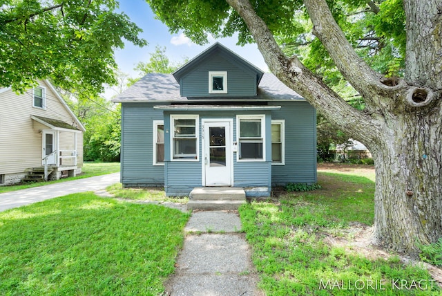 bungalow-style home featuring a front yard