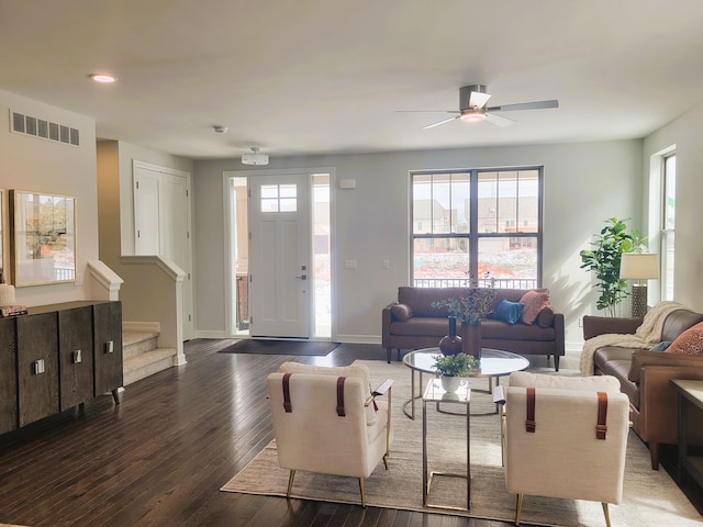 living room featuring dark hardwood / wood-style floors, a healthy amount of sunlight, and ceiling fan