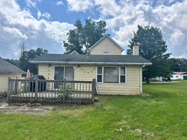 back of house with a lawn and a deck