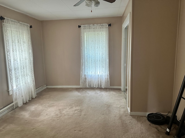 carpeted spare room with ceiling fan