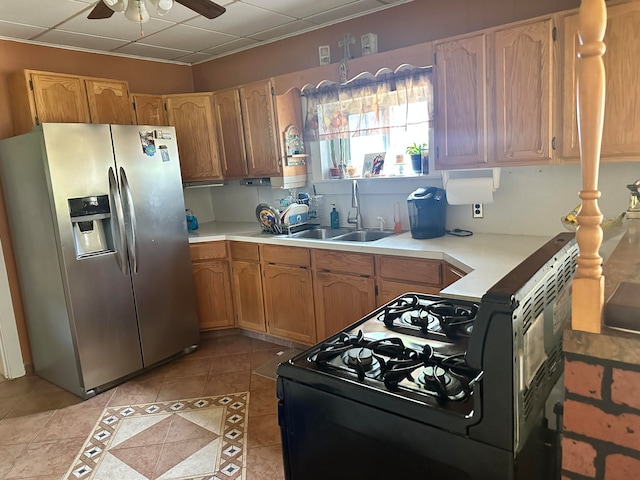 kitchen with ceiling fan, sink, black range with gas stovetop, stainless steel fridge with ice dispenser, and light tile patterned floors